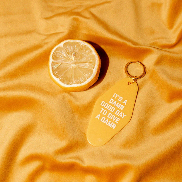 It's A Damn Good Day To Give A Damn Motel Keychain